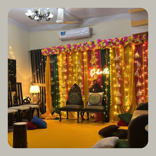 Indoor Dholki Decor with Neon Signage and Multicolored Fabric Backdrop
