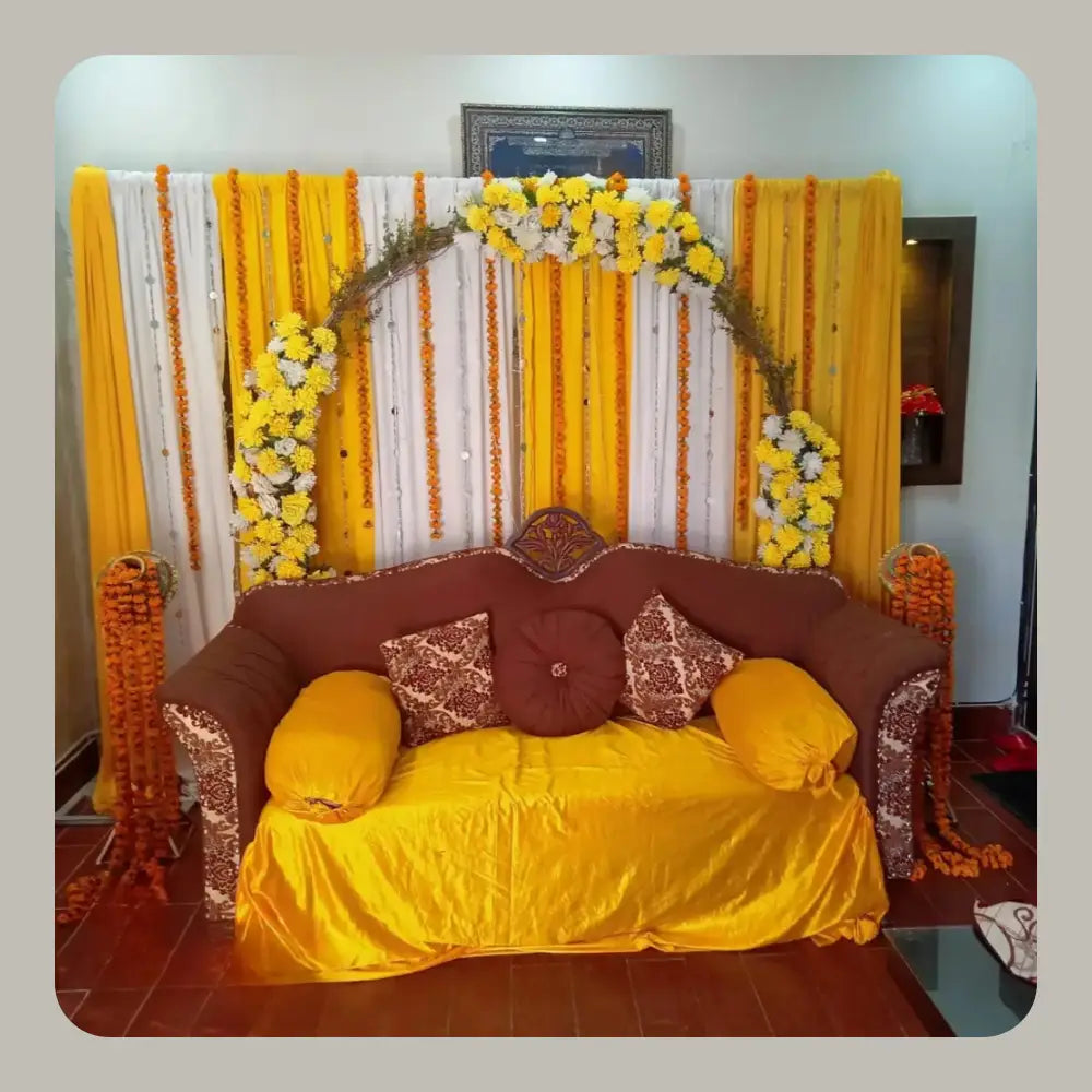 Traditional Yellow and White Mehndi Backdrop with Marigold Arch and Velvet Sofa