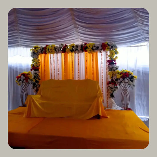 Classic Yellow and White Mehndi Stage with Floral Arch and Drapery