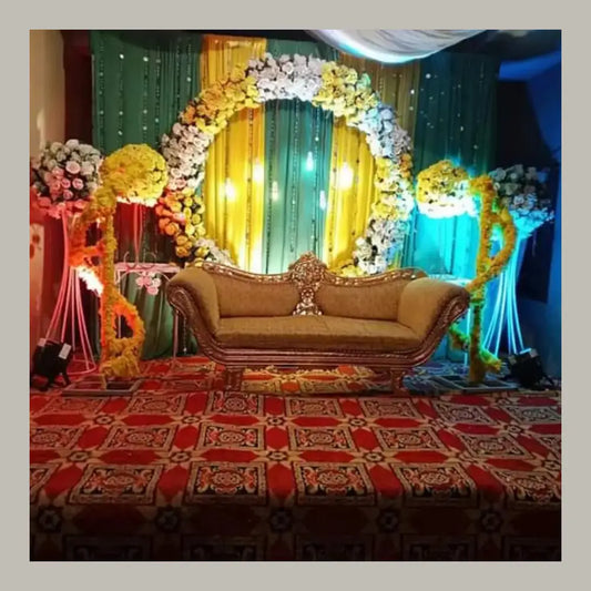 Grand Floral Arch Mehndi Stage with Royal Gold Seating and Marigold Draping