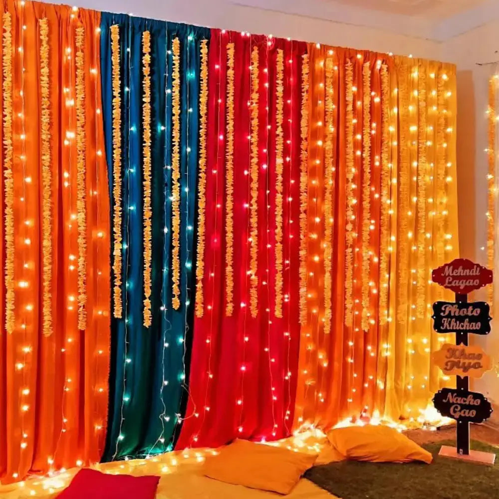 Multicolor Fabric Backdrop Mehndi Decor with Fairy Lights and Fun Signage