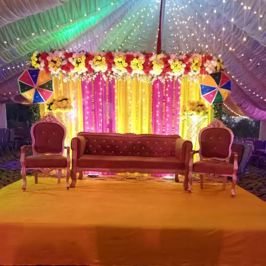 Elegant Mehndi Stage Decor with Marigold Backdrop and Fairy Light Canopy