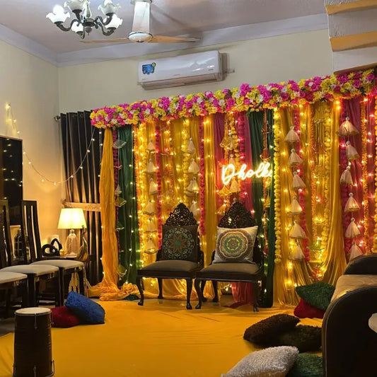Indoor Dholki Decor with Neon Signage and Multicolored Fabric Backdrop