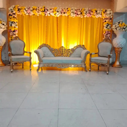 Elegant Golden Carved Mehndi Stage with Yellow Backdrop and Floral Arch