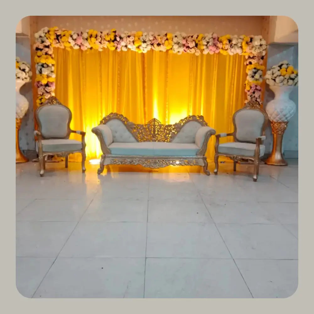 Elegant Golden Carved Mehndi Stage with Yellow Backdrop and Floral Arch