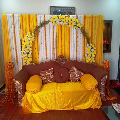Traditional Yellow and White Mehndi Backdrop with Marigold Arch and Velvet Sofa