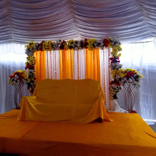 Classic Yellow and White Mehndi Stage with Floral Arch and Drapery