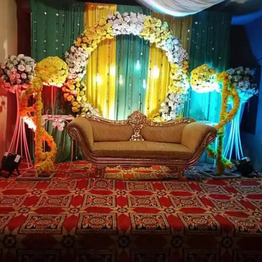Grand Floral Arch Mehndi Stage with Royal Gold Seating and Marigold Draping