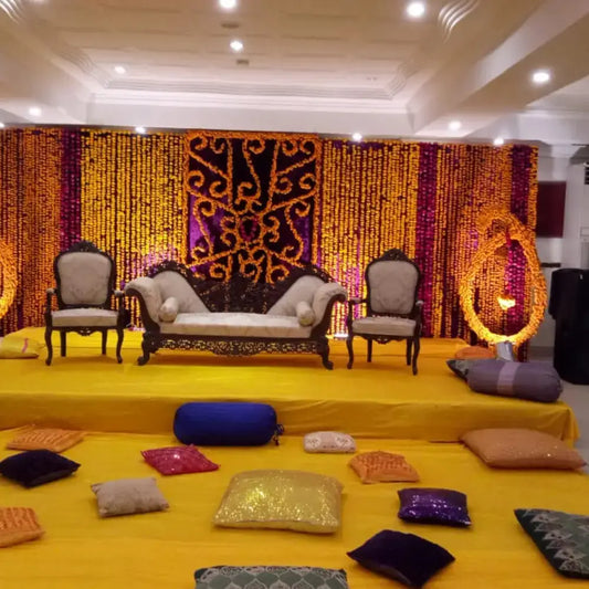 Vibrant Marigold Backdrop Mehndi Stage with Traditional Floor Seating