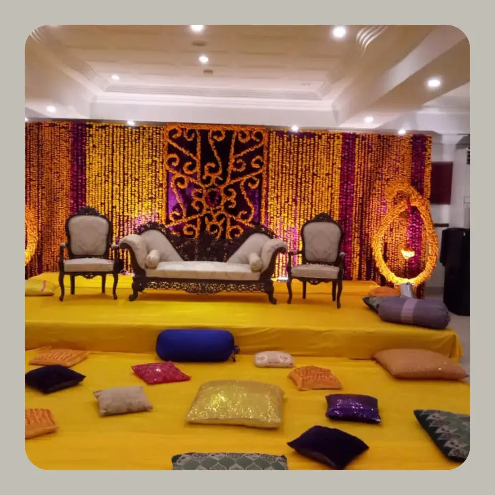 Vibrant Marigold Backdrop Mehndi Stage with Traditional Floor Seating