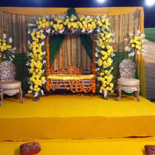 Traditional Green and Yellow Mehndi Jhoola Stage with Marigold Arch