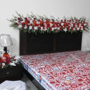 Simple Bridal Bed Decoration with Red, White and Orange Floral Headboard Garland