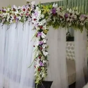 Bridal Bed Decoration with White Tulle Drapes and Lavender and White Floral Canopy