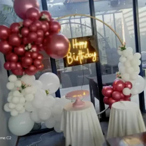 Burgundy and White Balloon Hoop Birthday Decoration with Neon Sign and Cake Table