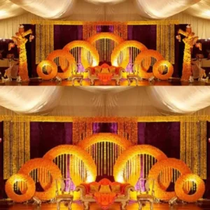 Mehndi Stage Decoration with Marigold Flower Arches, Purple Velvet Backdrop and Hanging Garlands